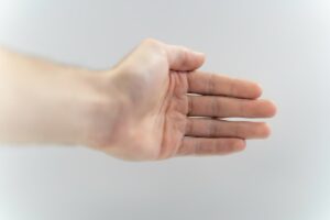 a hand holding a yellow towel