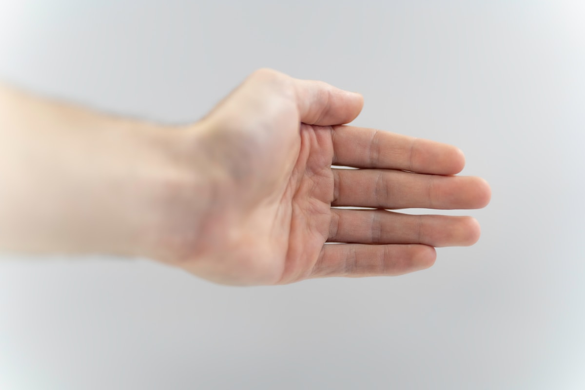 a hand holding a yellow towel