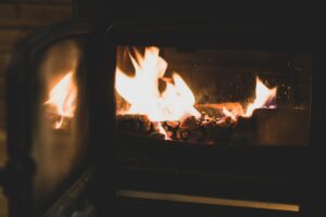 a fire burning inside of a wood burning stove