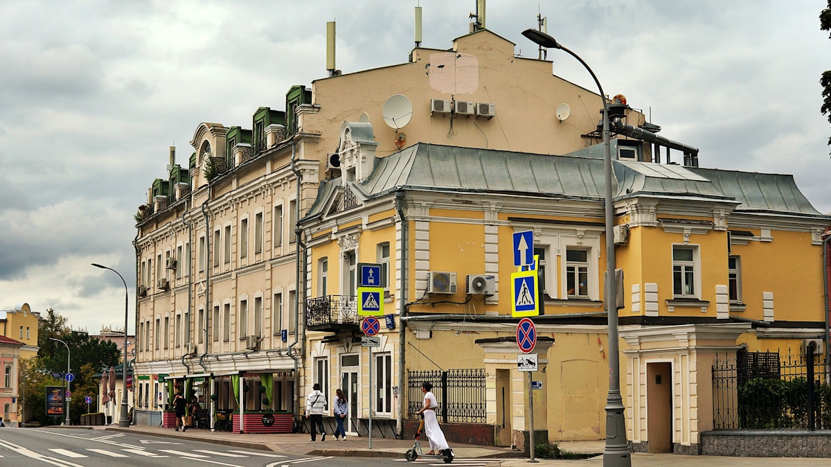 A yellow building with multiple windows and balconies.