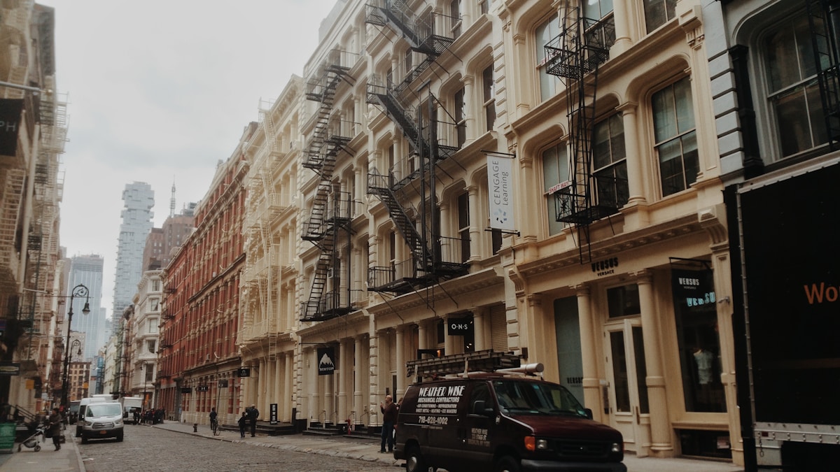 Rues de New York avec bâtiments historiques et voitures garées.